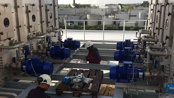 Technicians installing an NH3 scrubber on a roof